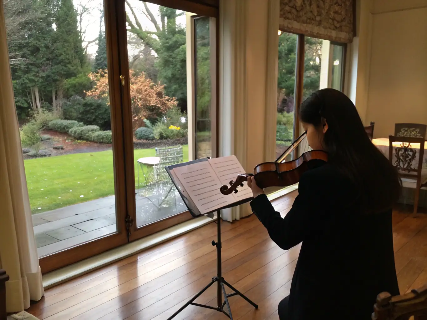 A focused young student practicing violin with their instructor in a well-lit studio, showcasing personalized attention and guidance.